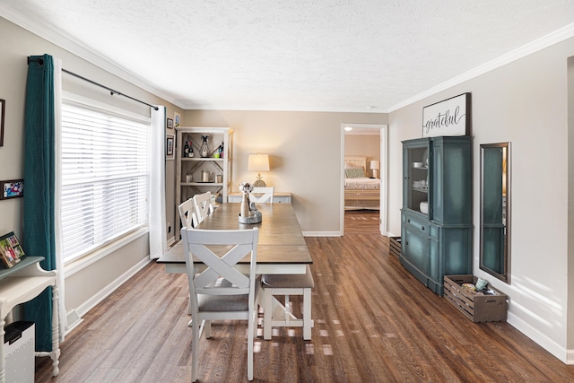 dining area featuring ornamental molding, hardwood / wood-style floors, and a textured ceiling