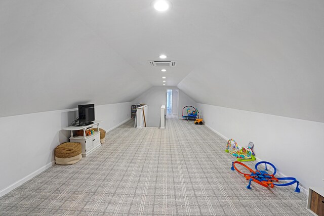 game room featuring vaulted ceiling and light carpet