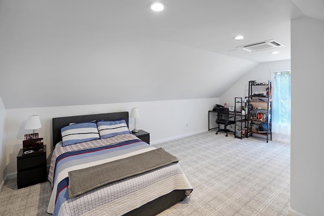 bedroom with vaulted ceiling and light colored carpet