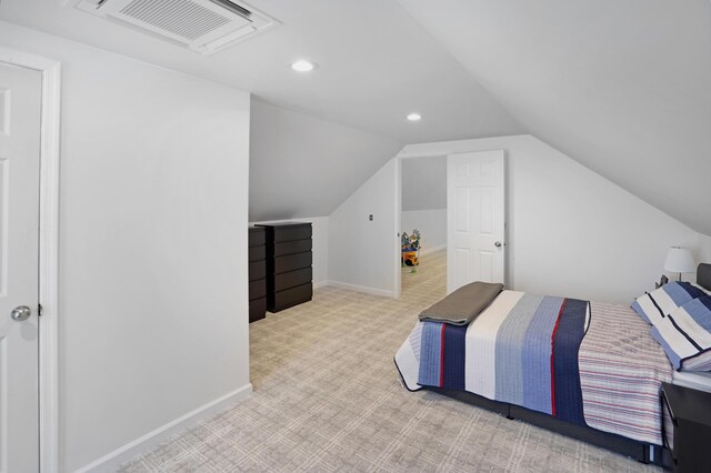 carpeted bedroom with vaulted ceiling