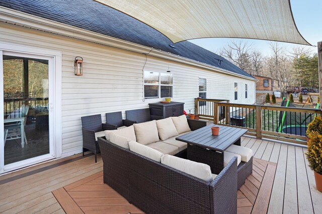 wooden deck with a playground and outdoor lounge area