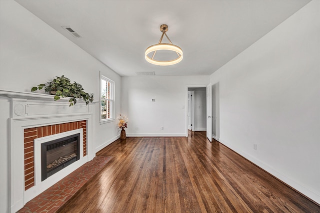 unfurnished living room with a fireplace and dark hardwood / wood-style floors