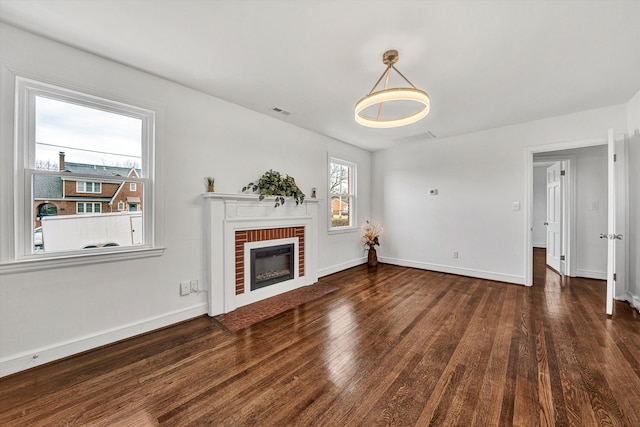 unfurnished living room with a fireplace and dark hardwood / wood-style floors