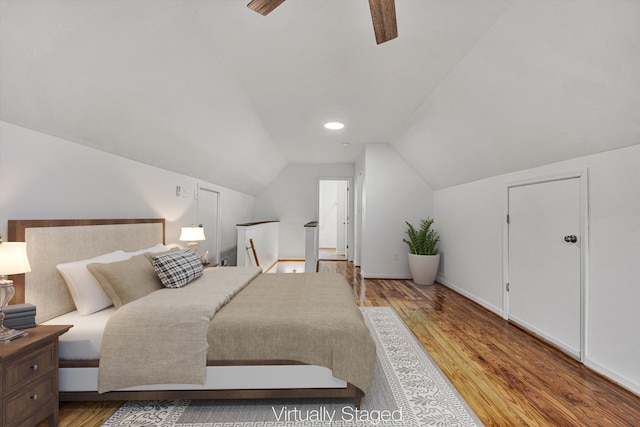 bedroom featuring hardwood / wood-style flooring, lofted ceiling, and ceiling fan