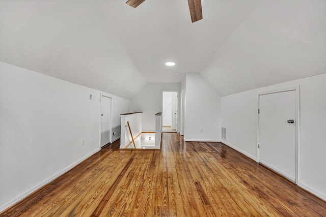 additional living space featuring lofted ceiling, hardwood / wood-style floors, and ceiling fan