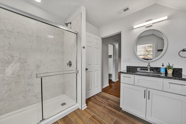 bathroom featuring vanity and a shower with shower door