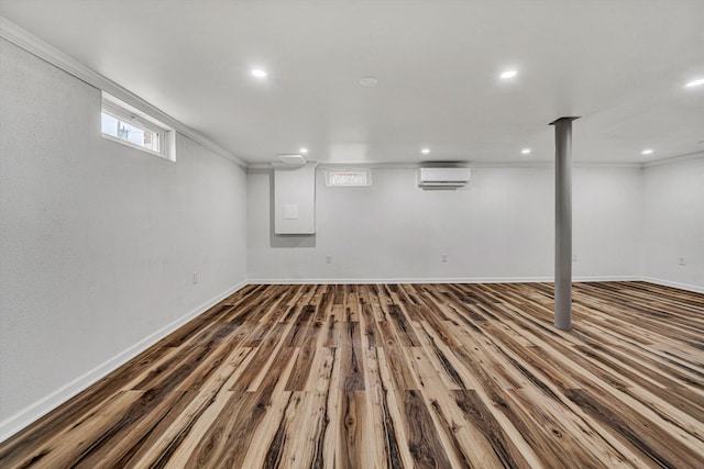 basement featuring hardwood / wood-style flooring and a wall unit AC