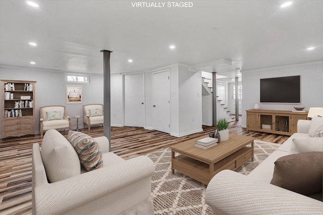 living room featuring crown molding and hardwood / wood-style floors