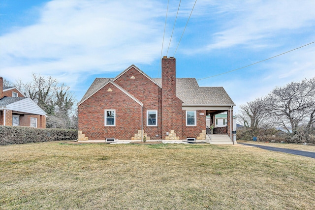 rear view of property featuring covered porch and a lawn