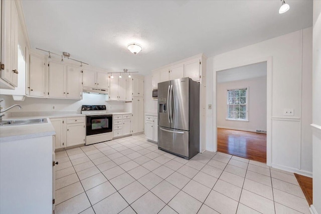 kitchen with white cabinetry, stainless steel fridge with ice dispenser, electric range oven, and sink