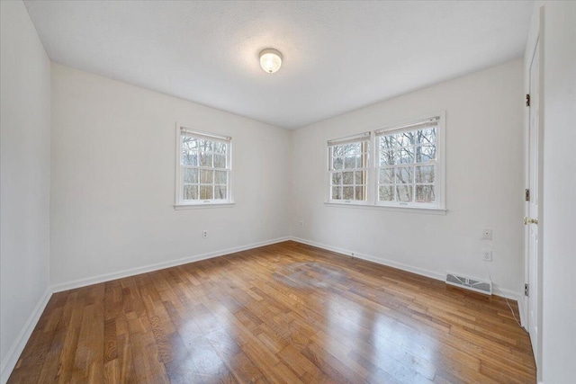 unfurnished room featuring hardwood / wood-style floors