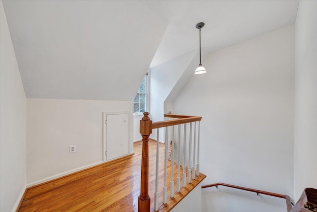 additional living space featuring lofted ceiling and light hardwood / wood-style flooring