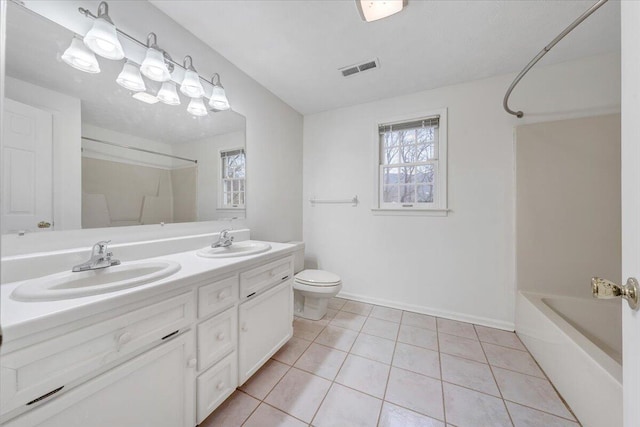 full bathroom featuring tile patterned flooring, vanity, bathing tub / shower combination, and toilet