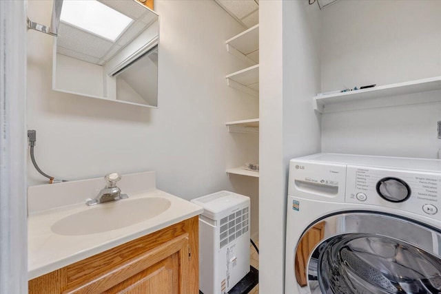 clothes washing area featuring washer / dryer and sink