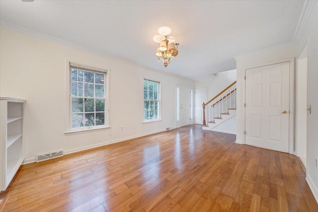 unfurnished living room with crown molding, a chandelier, and light hardwood / wood-style floors