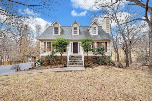 cape cod-style house featuring a front yard