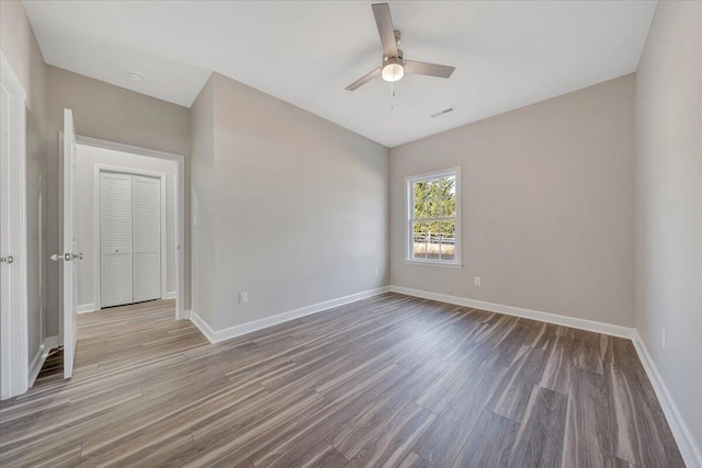 unfurnished room featuring hardwood / wood-style flooring and ceiling fan