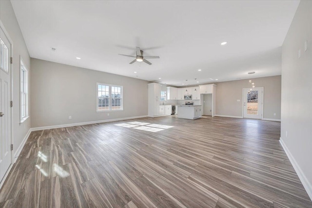 unfurnished living room with hardwood / wood-style floors and ceiling fan