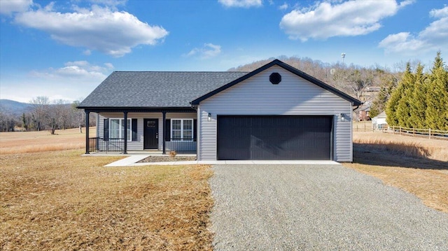 ranch-style home with a porch, a garage, and a front yard