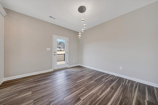 empty room featuring dark hardwood / wood-style flooring