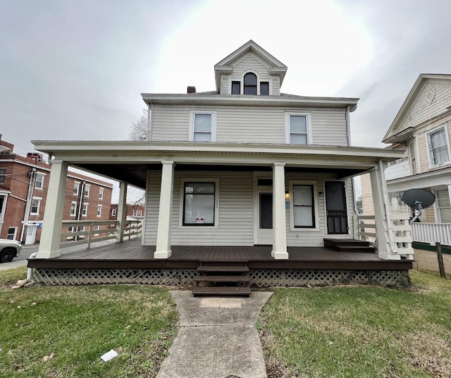 view of front of home featuring a front lawn and covered porch