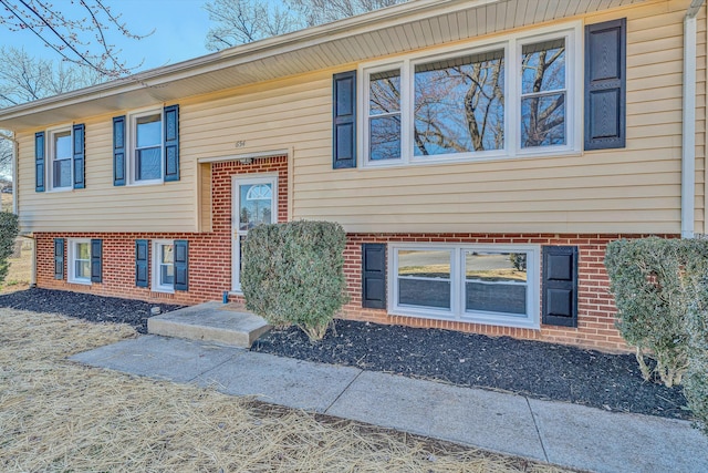 raised ranch featuring brick siding