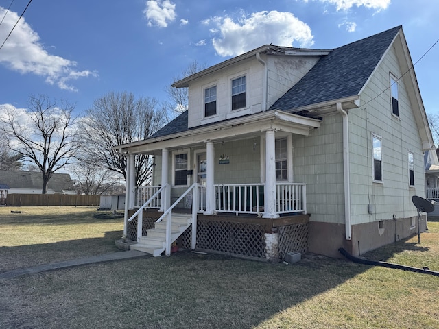 bungalow with a porch and a front lawn