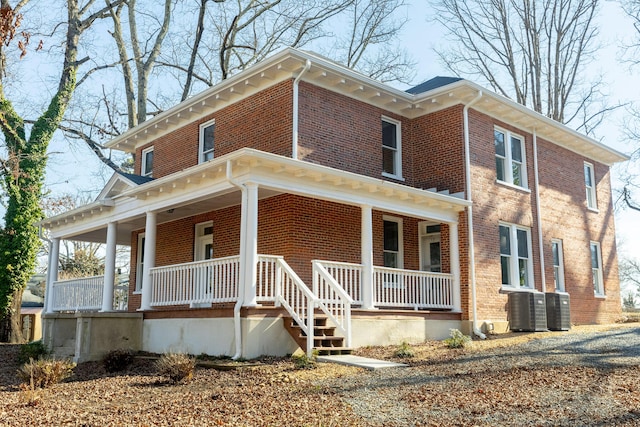 view of front of property featuring cooling unit and a porch