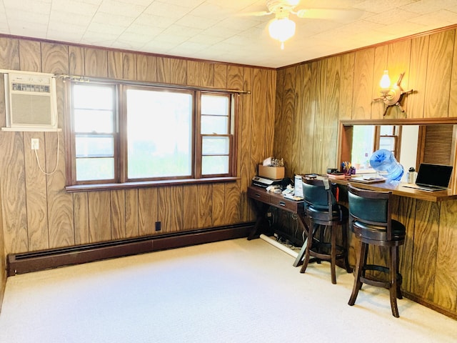 office featuring ceiling fan, wooden walls, a baseboard radiator, light colored carpet, and an AC wall unit