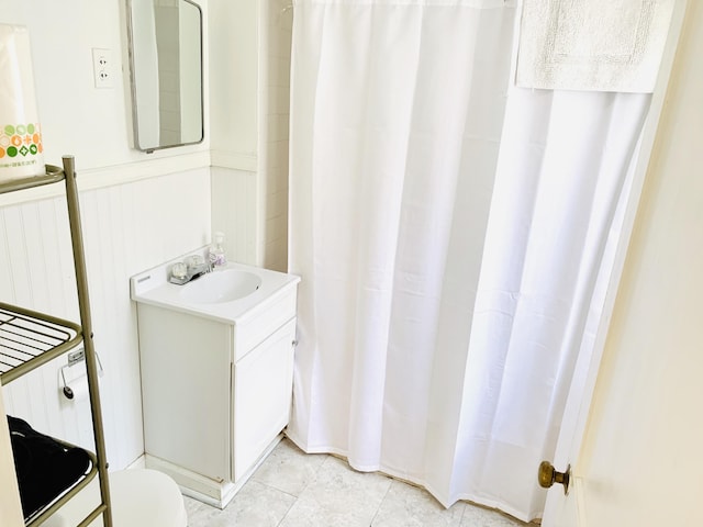 bathroom featuring vanity, tile patterned flooring, and toilet