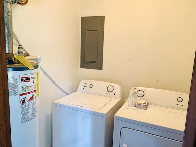 washroom with water heater, washer and dryer, and electric panel