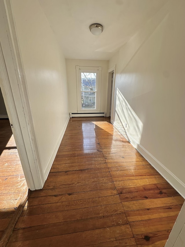 hall featuring hardwood / wood-style floors and baseboard heating