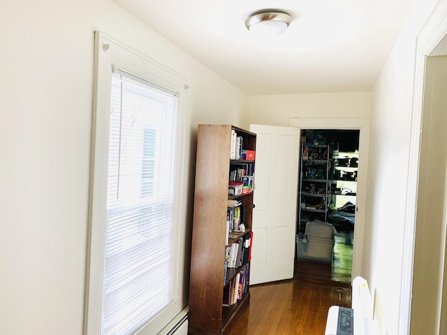 corridor with hardwood / wood-style floors