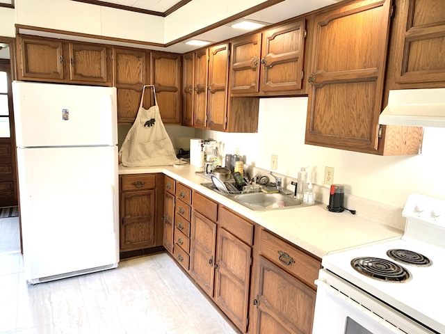 kitchen featuring crown molding, sink, and white appliances