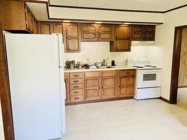 kitchen with crown molding, white appliances, and sink