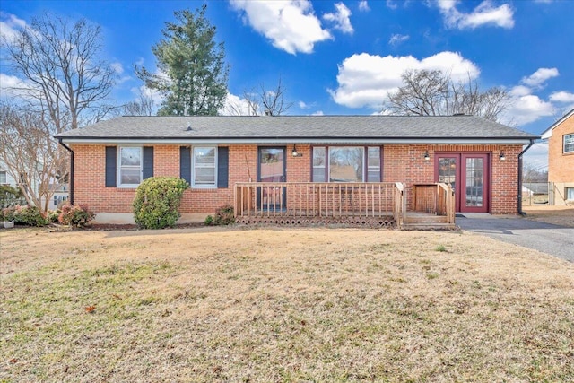 single story home with french doors, a deck, and a front lawn