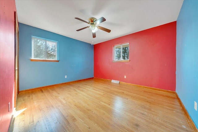 spare room with light hardwood / wood-style floors and ceiling fan