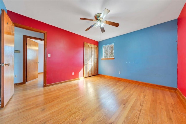 unfurnished bedroom featuring ceiling fan, a closet, and light hardwood / wood-style flooring