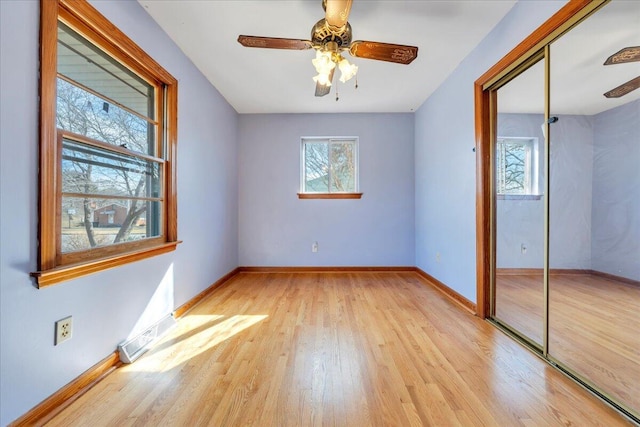 unfurnished bedroom with ceiling fan, light hardwood / wood-style floors, and a closet