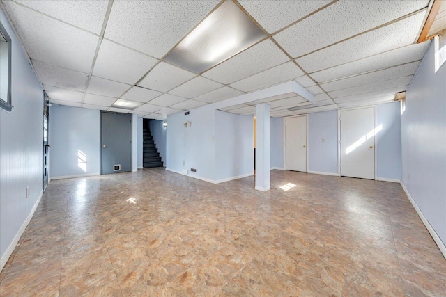 basement with a paneled ceiling