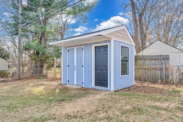 view of outbuilding with a yard