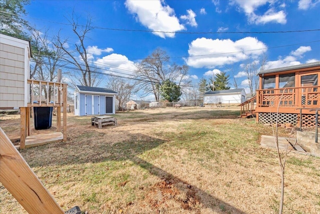 view of yard featuring a deck and a shed