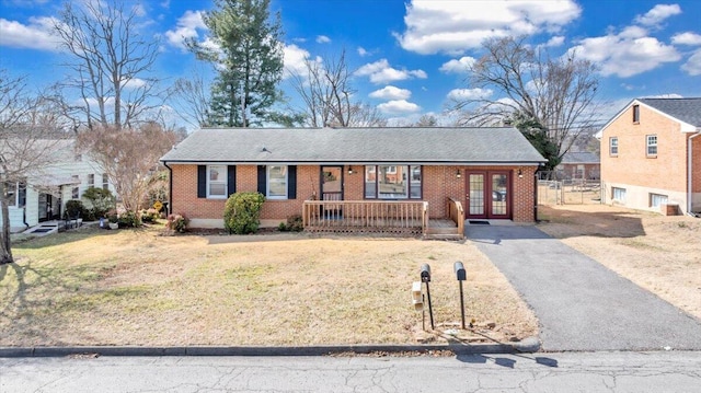 single story home featuring a front lawn and covered porch