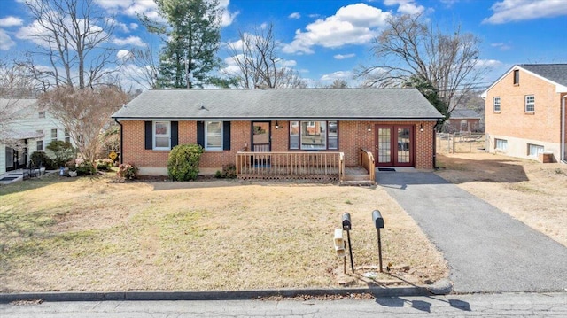 single story home featuring a front yard and covered porch