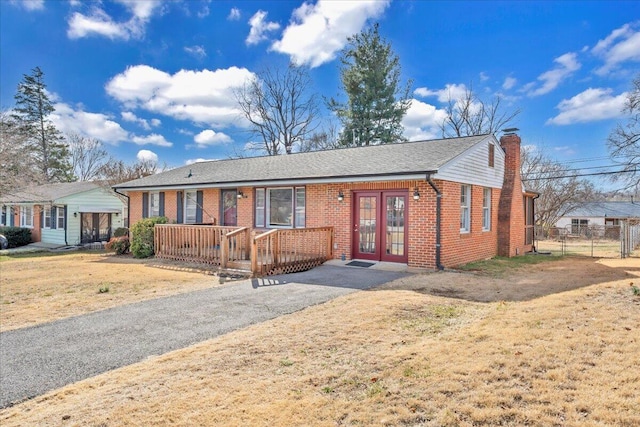 single story home featuring french doors and a front yard