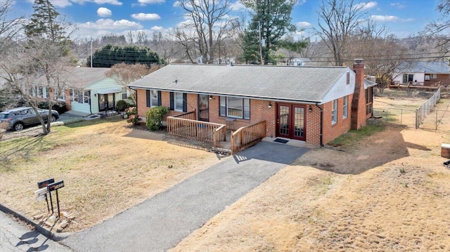 view of front of house with covered porch and french doors