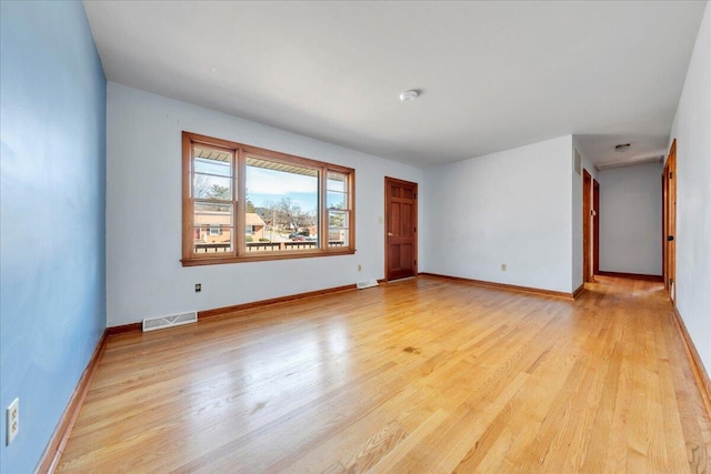 unfurnished room with light wood-type flooring