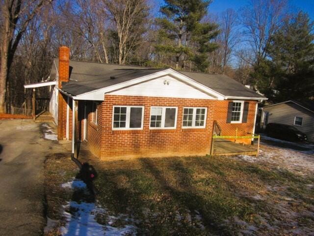 view of property exterior with a carport