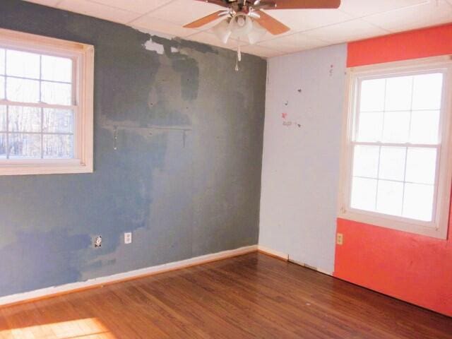 unfurnished room featuring hardwood / wood-style floors and ceiling fan