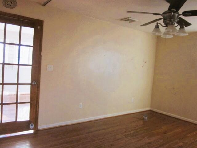 empty room featuring ceiling fan and dark hardwood / wood-style flooring